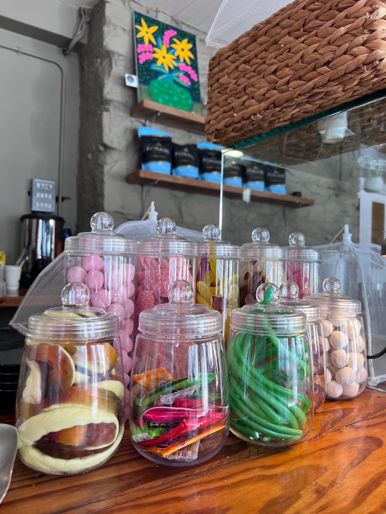 Colourful jars of sweets on the wooden counter at Cupán C