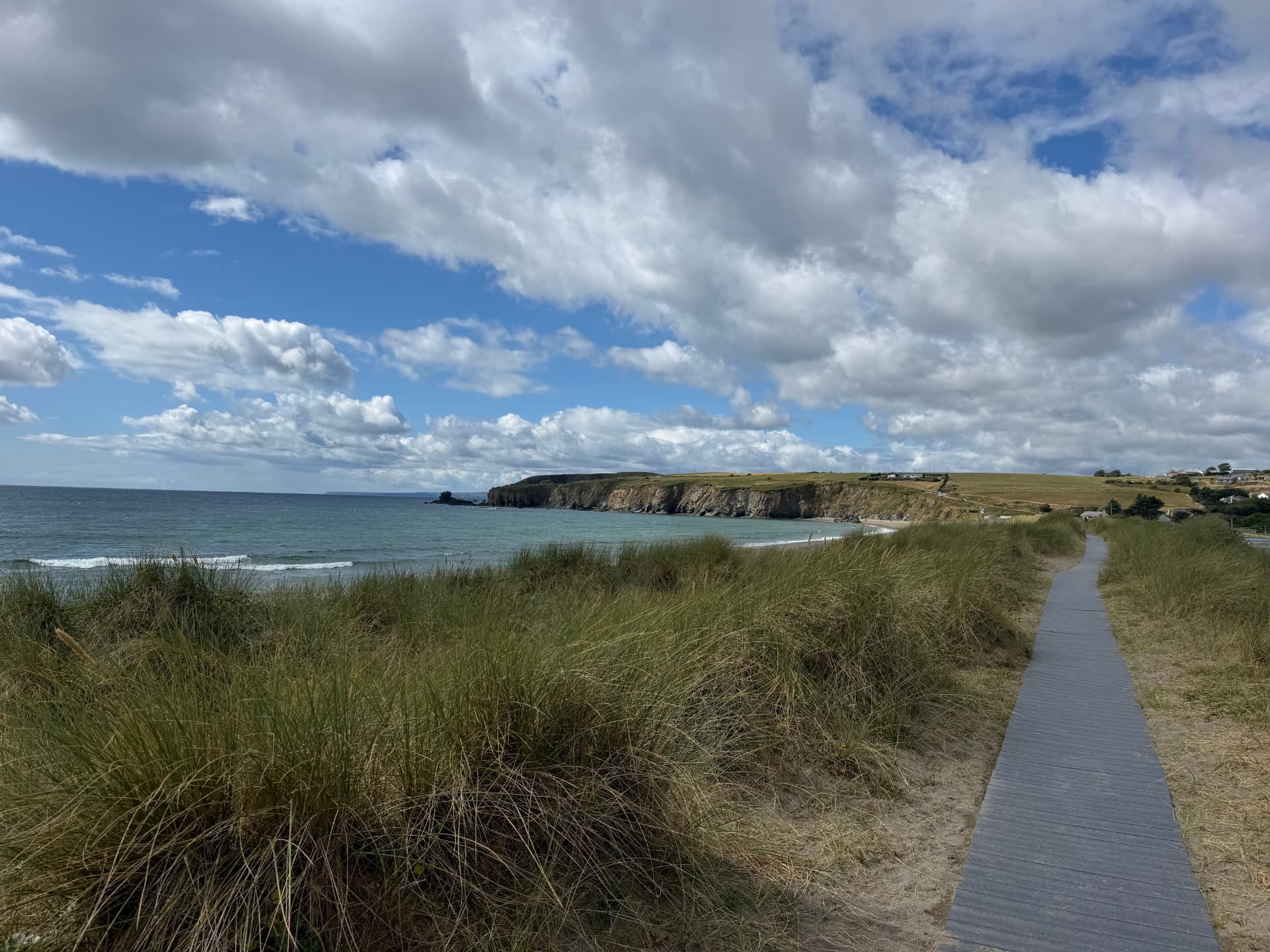 Boardwalk through the dunes to Bunmahon beach with the Copper Coast cliffs in the distance